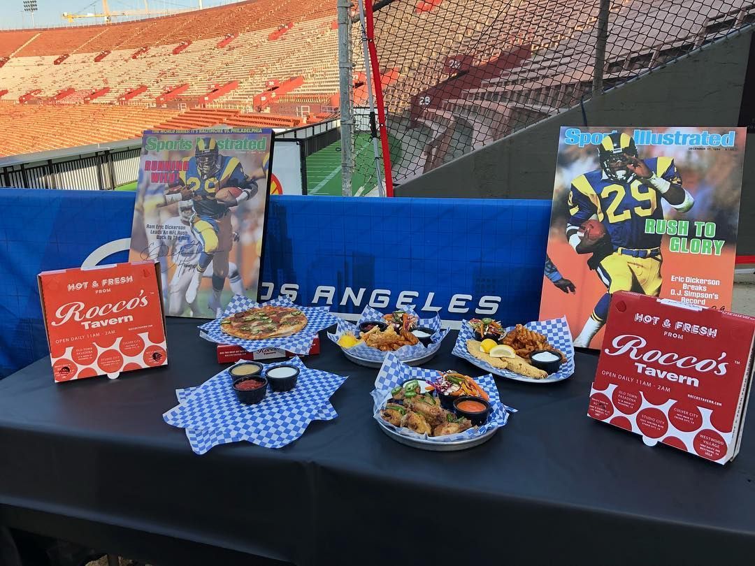A table with plates of food and magazines on it