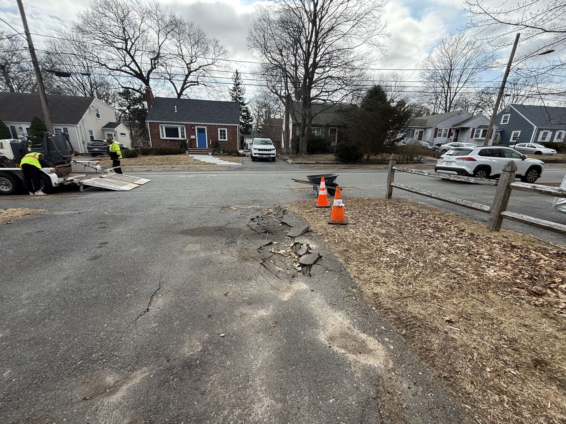 A group of people are standing on the side of a road.