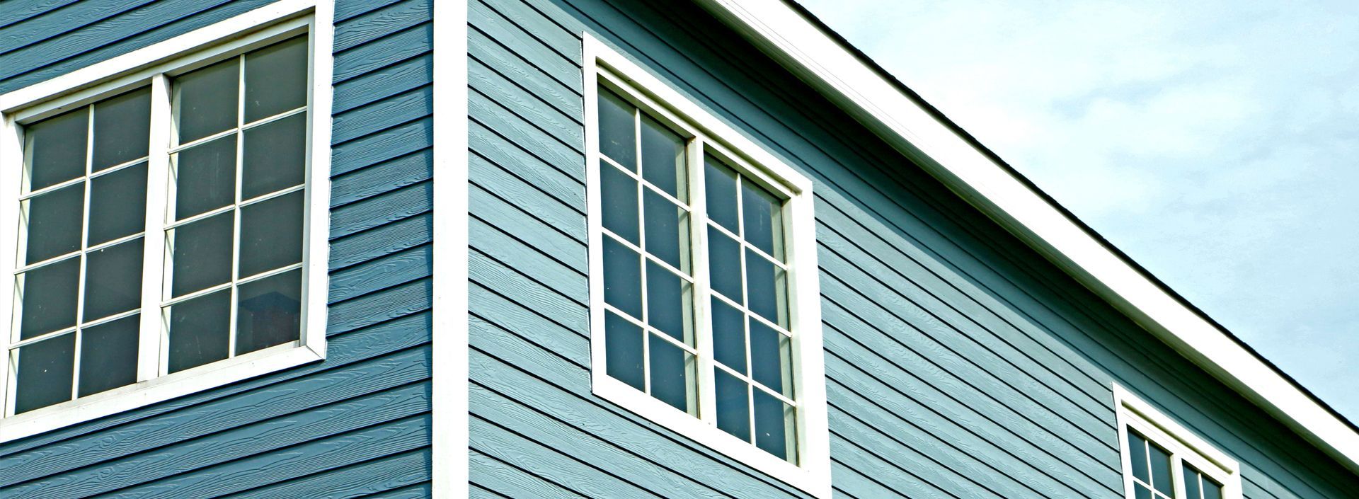 A blue house with white windows