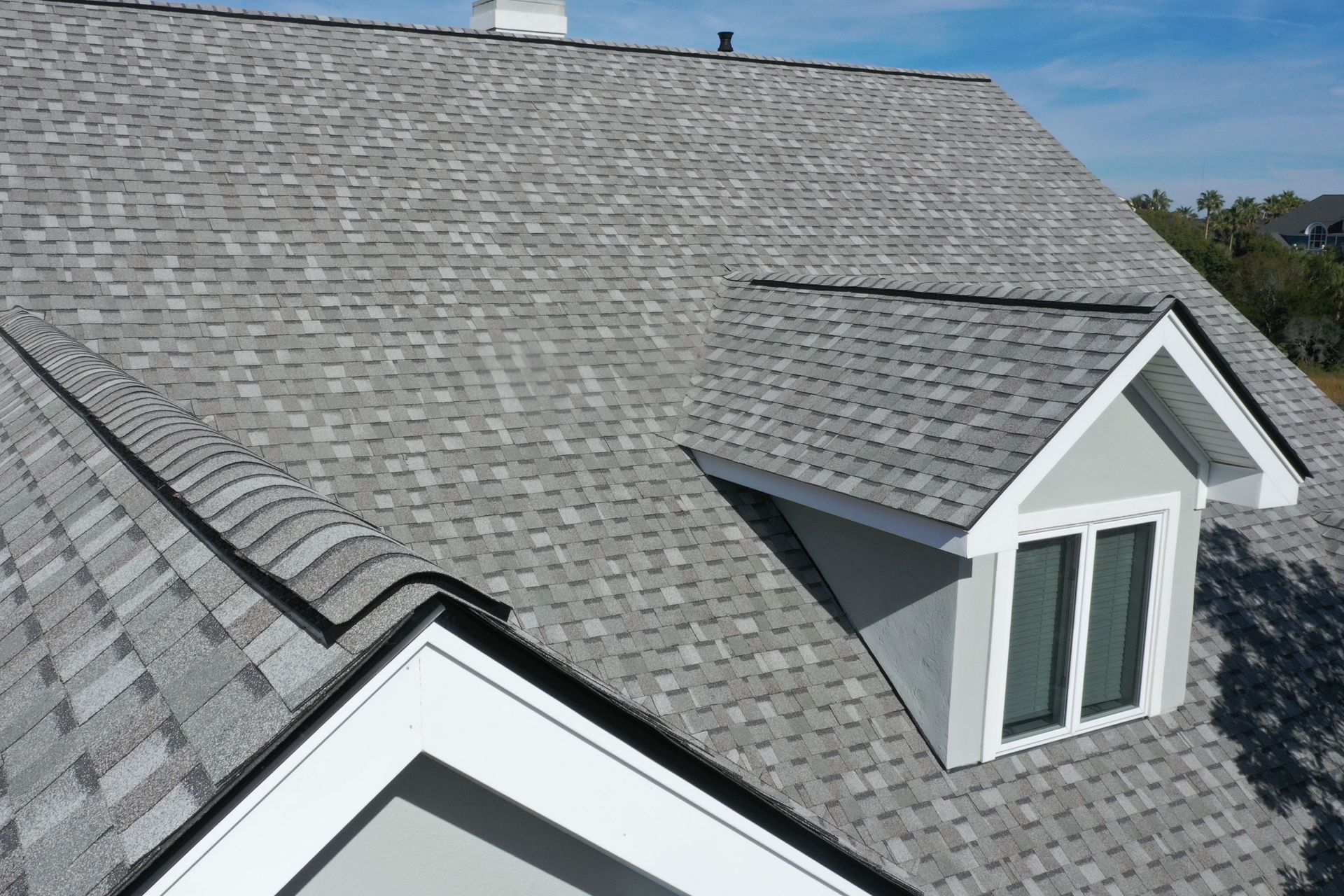A house with a gray roof and a window