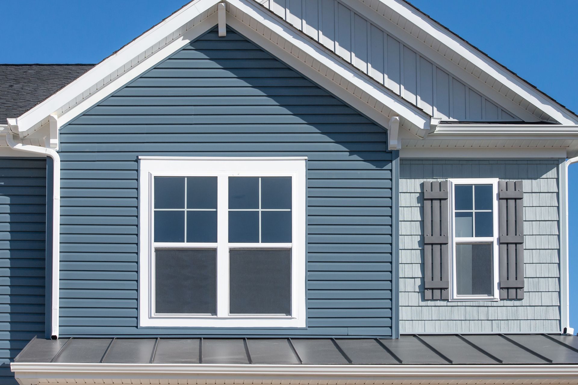 A house with a gray roof and a window