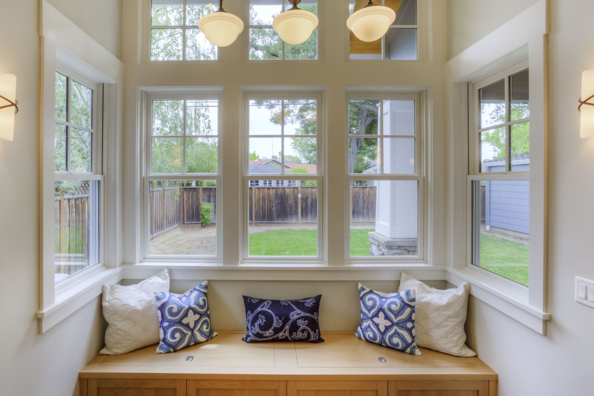 A window seat with blue and white pillows