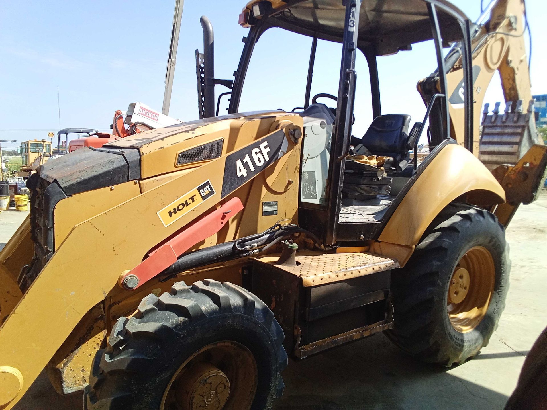 Yellow Case 416F backhoe on a sunny day.