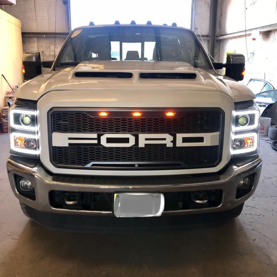 A white ford truck is parked in a garage.
