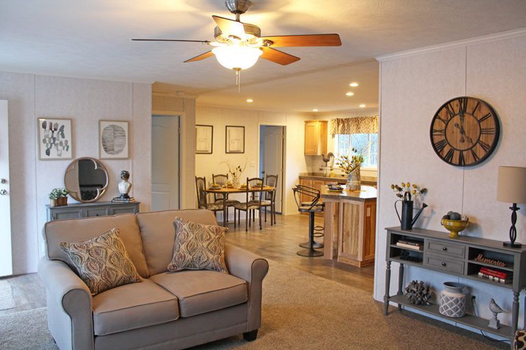 A living room with a couch and a ceiling fan