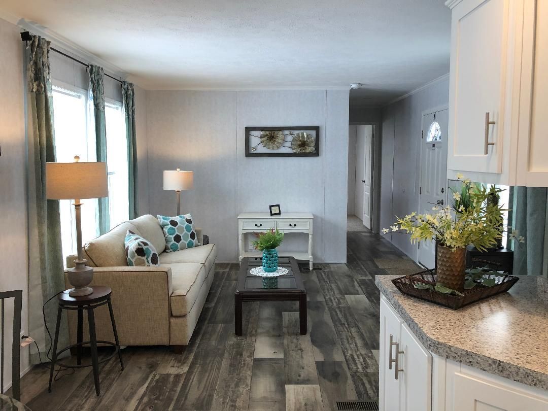 A living room in a mobile home with a couch and a coffee table.