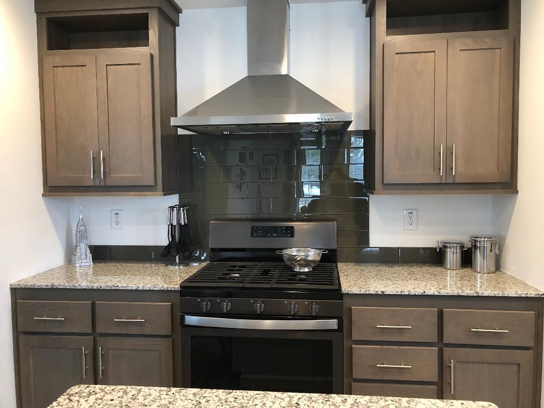 A kitchen with stainless steel appliances and granite counter tops.