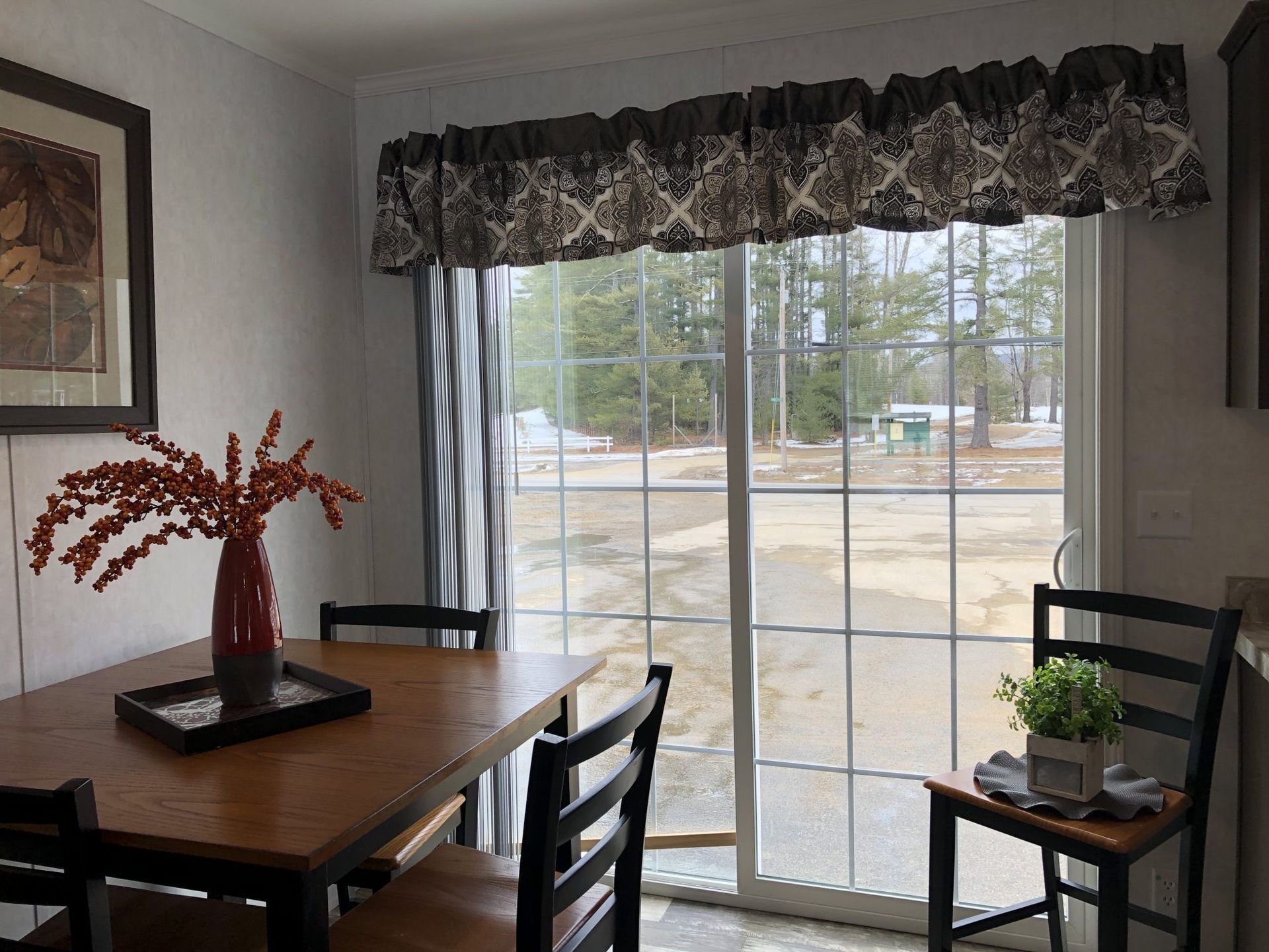 A dining room with a table and chairs and a sliding glass door