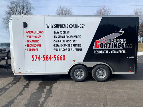 White trailer with Supreme Coatings LLC business signage and red phone number on the side.