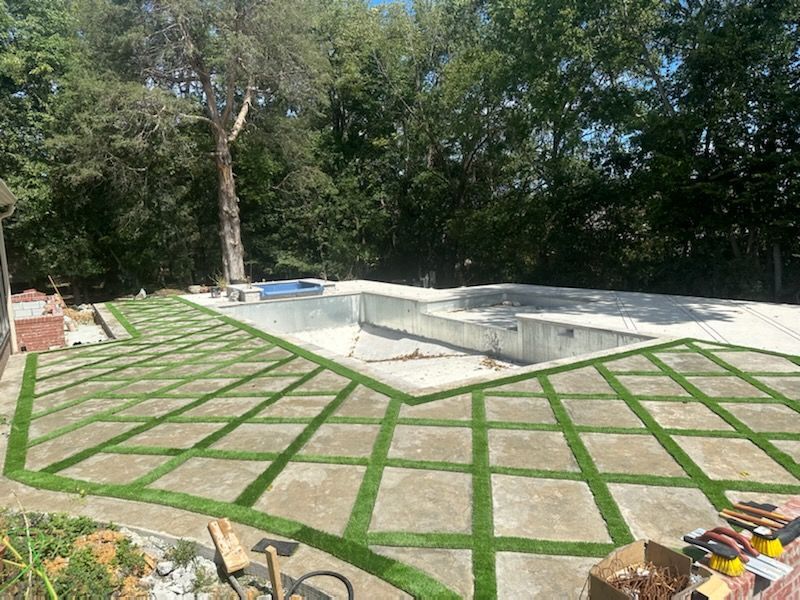a swimming pool is being built in the backyard of a house