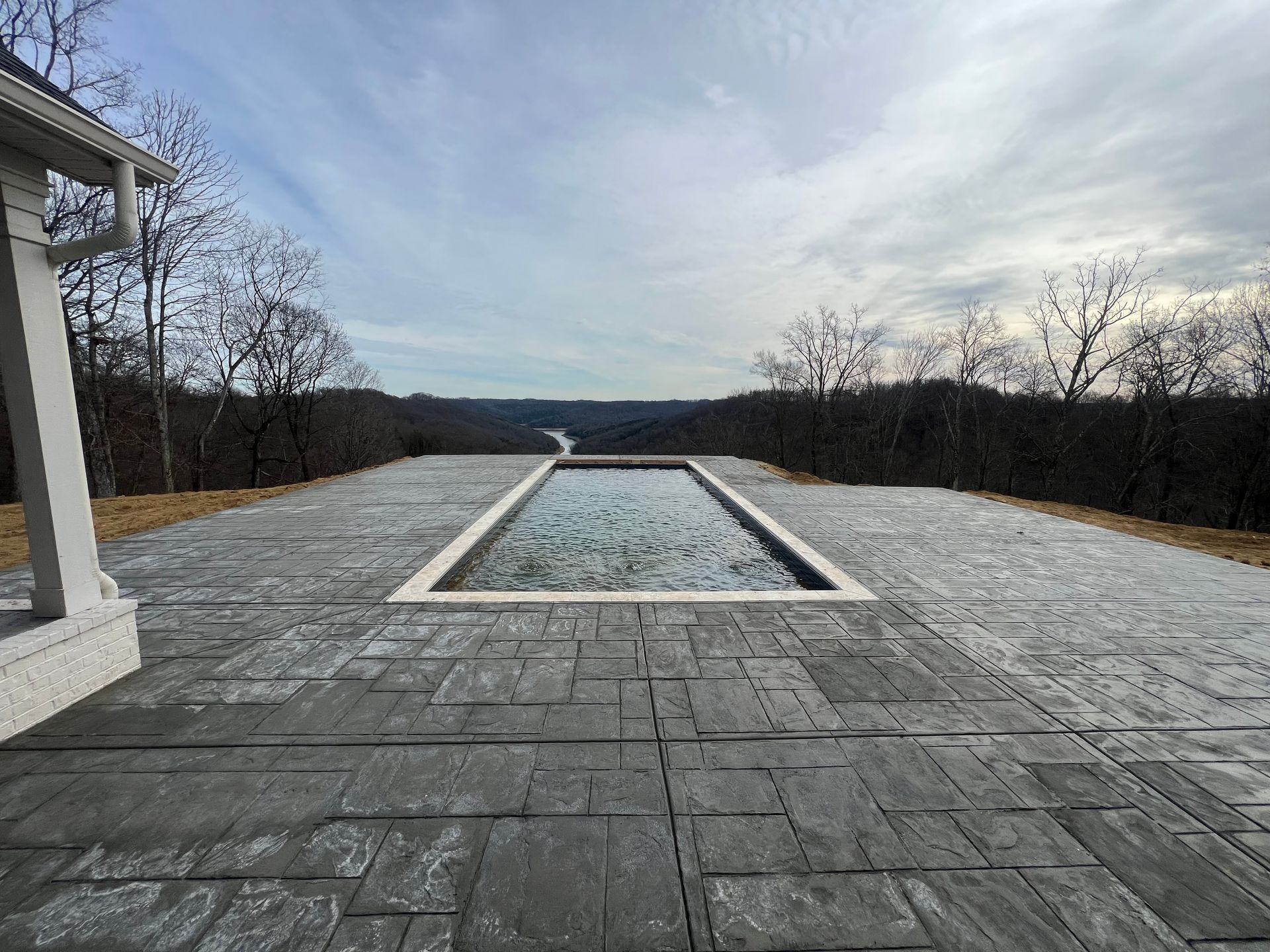 there is a large swimming pool in the middle of the patio.