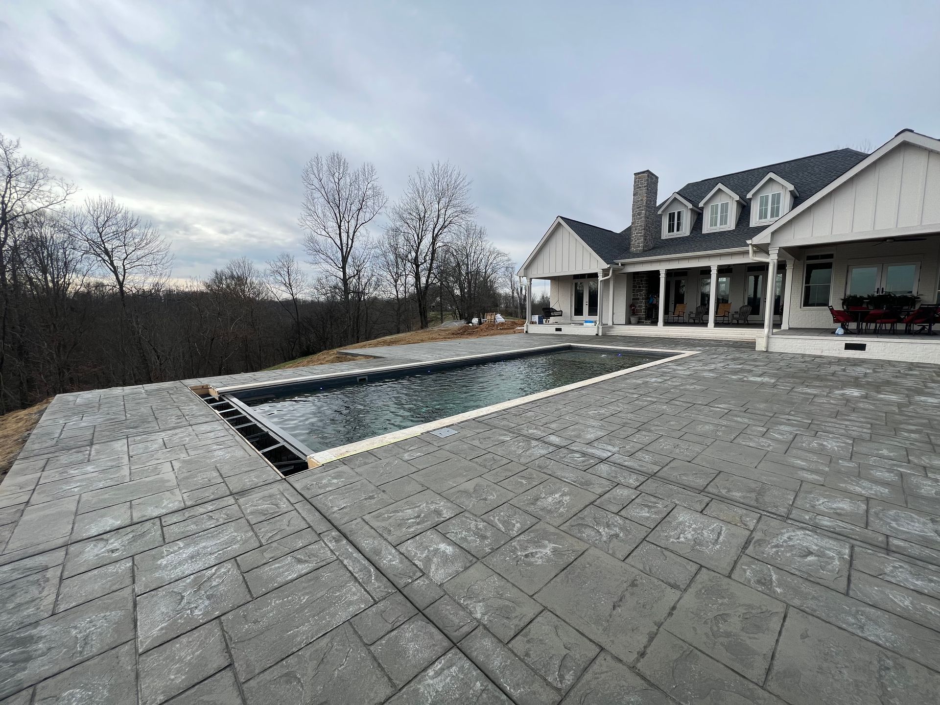 a large house with a large swimming pool in front of it.