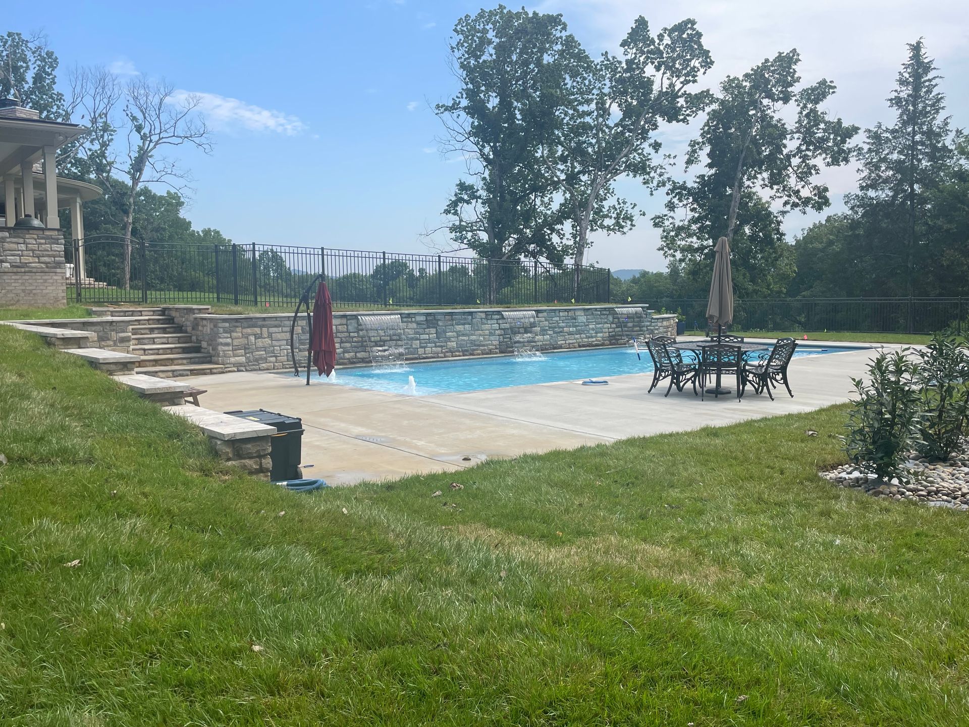 a large swimming pool in the backyard of a house