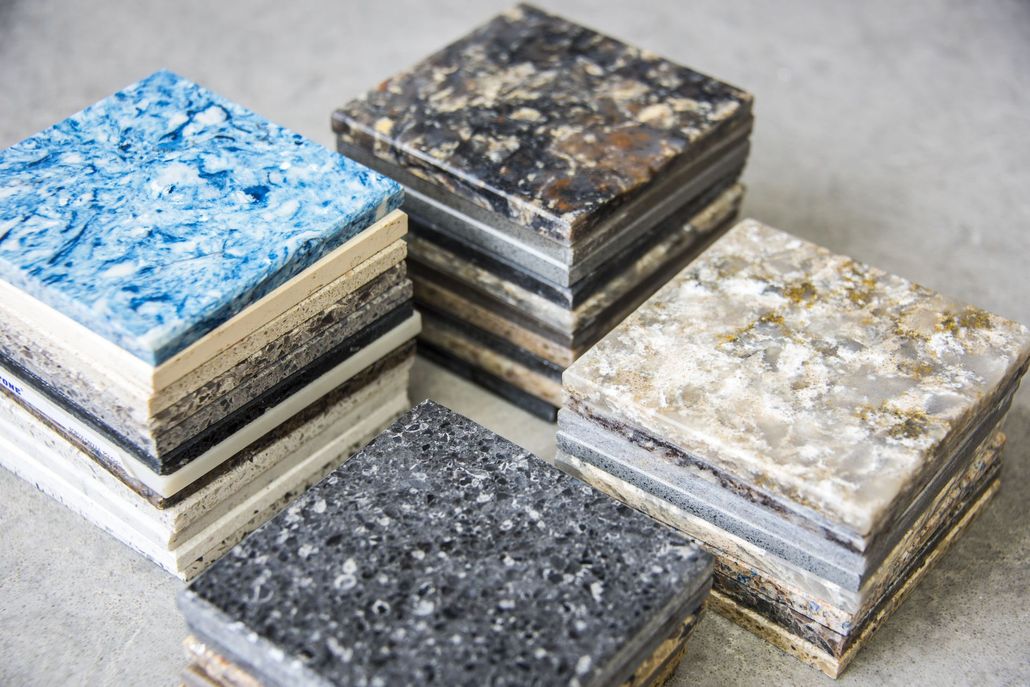 Stacks of square, multi-colored recycled plastic samples.