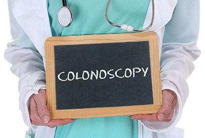 Doctor holding a board with the word Colonoscopy written on it