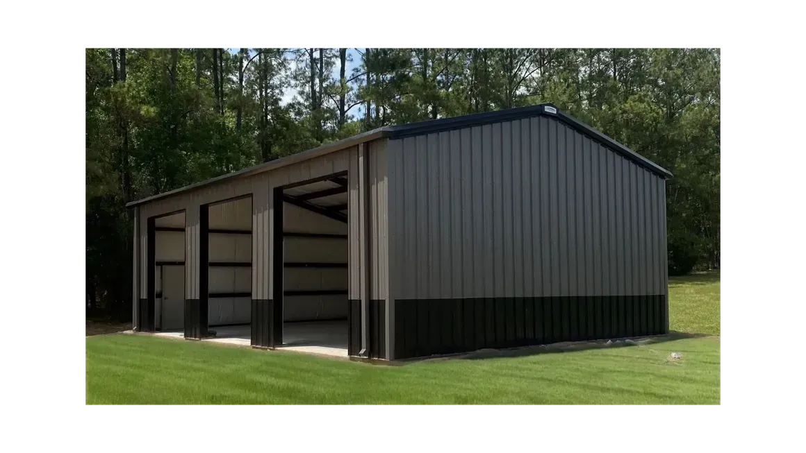 Black metal carport or storage shed with open bays, set on grass beside a wooded area.