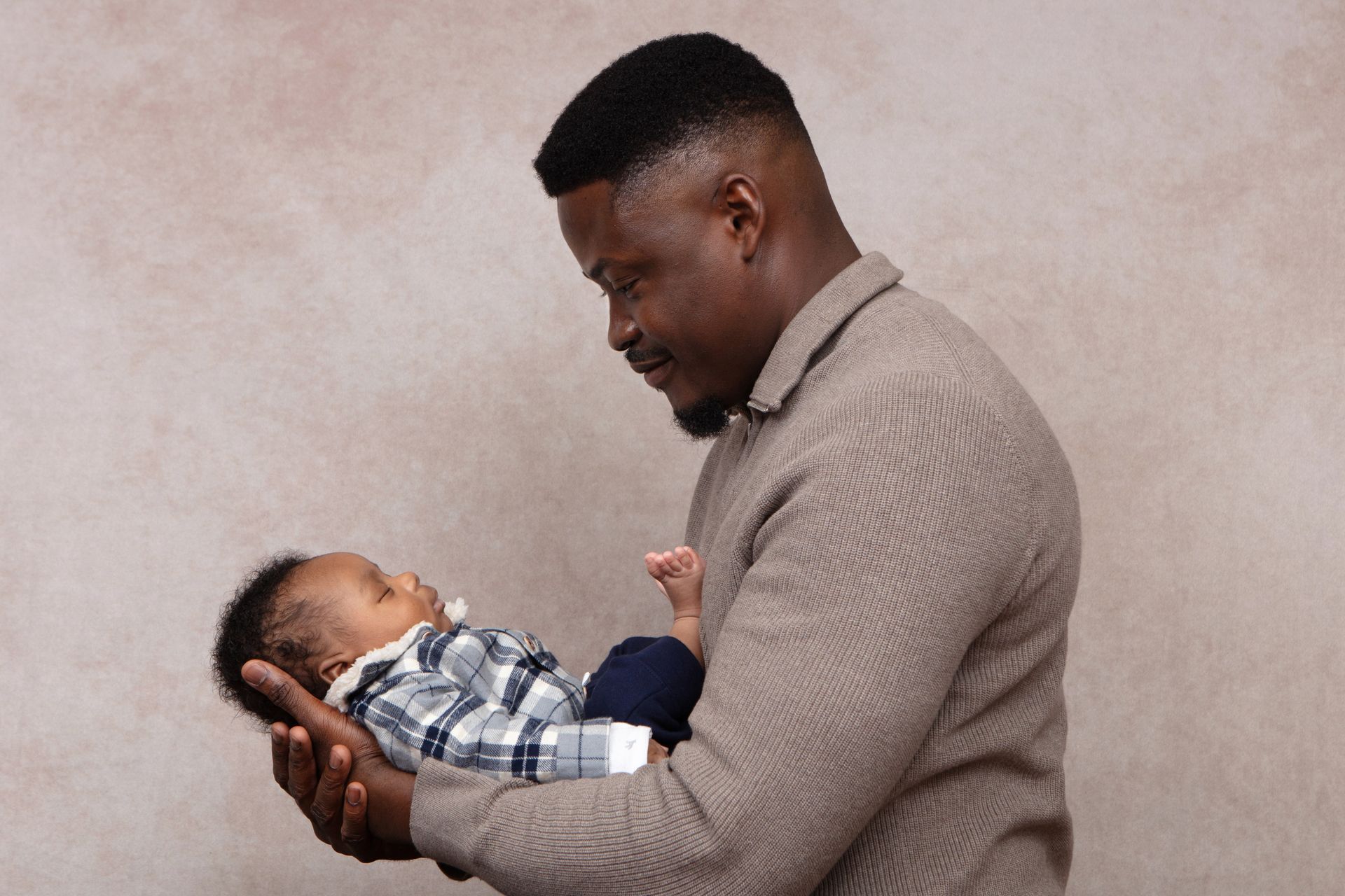 A man is holding a baby in his arms.