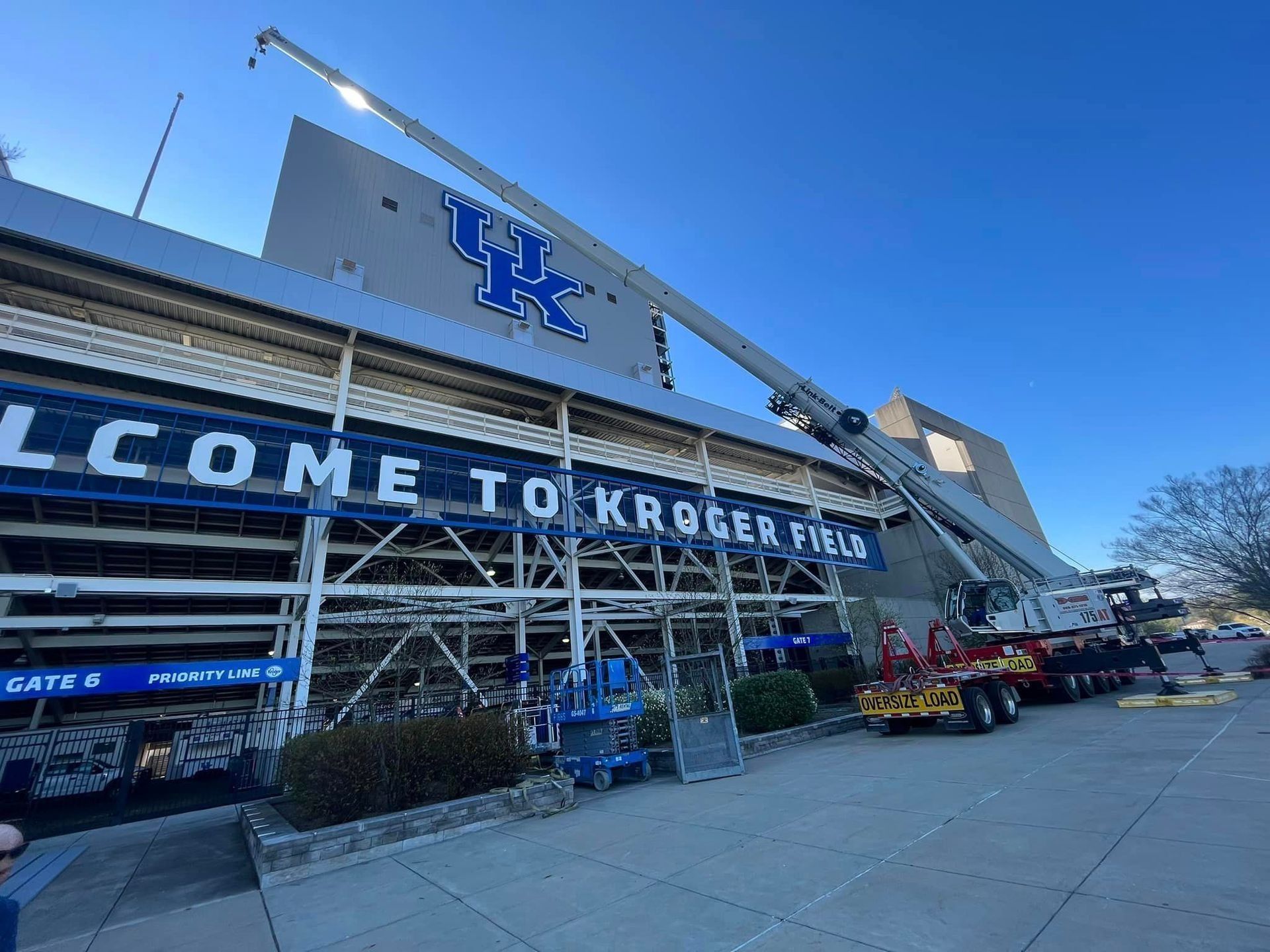 Kroger Field stadium sign, with a crane in use. Blue and white, sunny day.