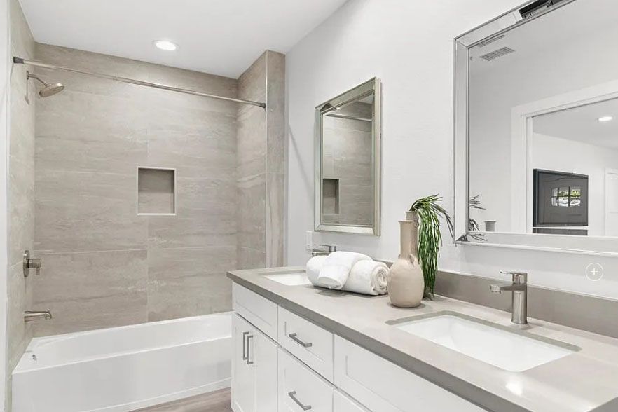 Modern white bathroom with walk-in shower, tub, vanity, and large mirror