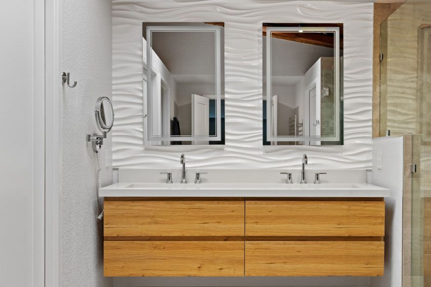 Modern bathroom vanity with double sinks, two mirrors, and wood drawers