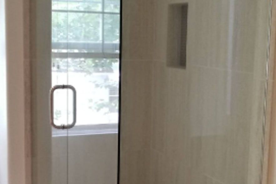 Hallway with a glass door and window, showing a bright exterior outside.