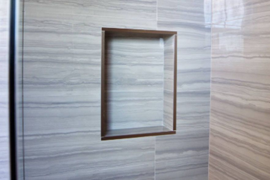 Wood-paneled wall with a small rectangular recessed opening
