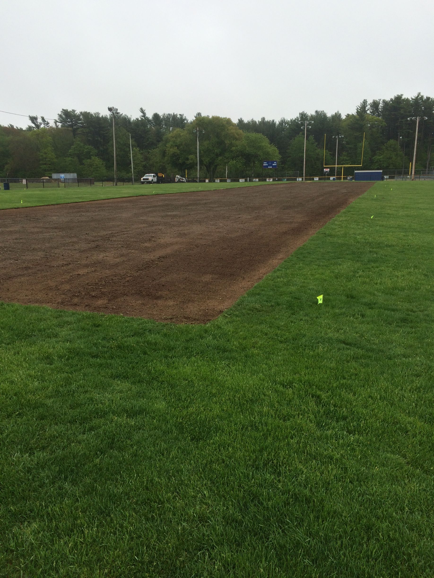A baseball field with a lot of grass and dirt.