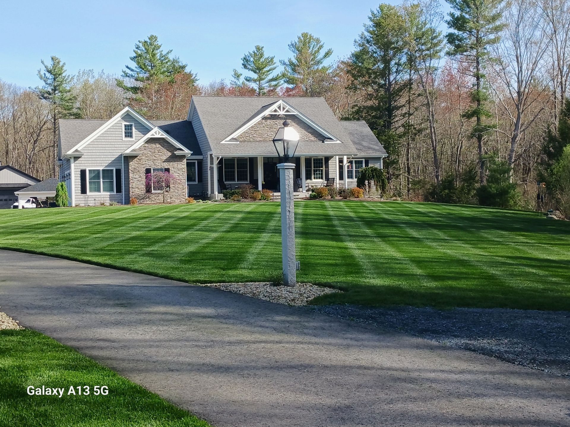 A large house with a lush green lawn in front of it.