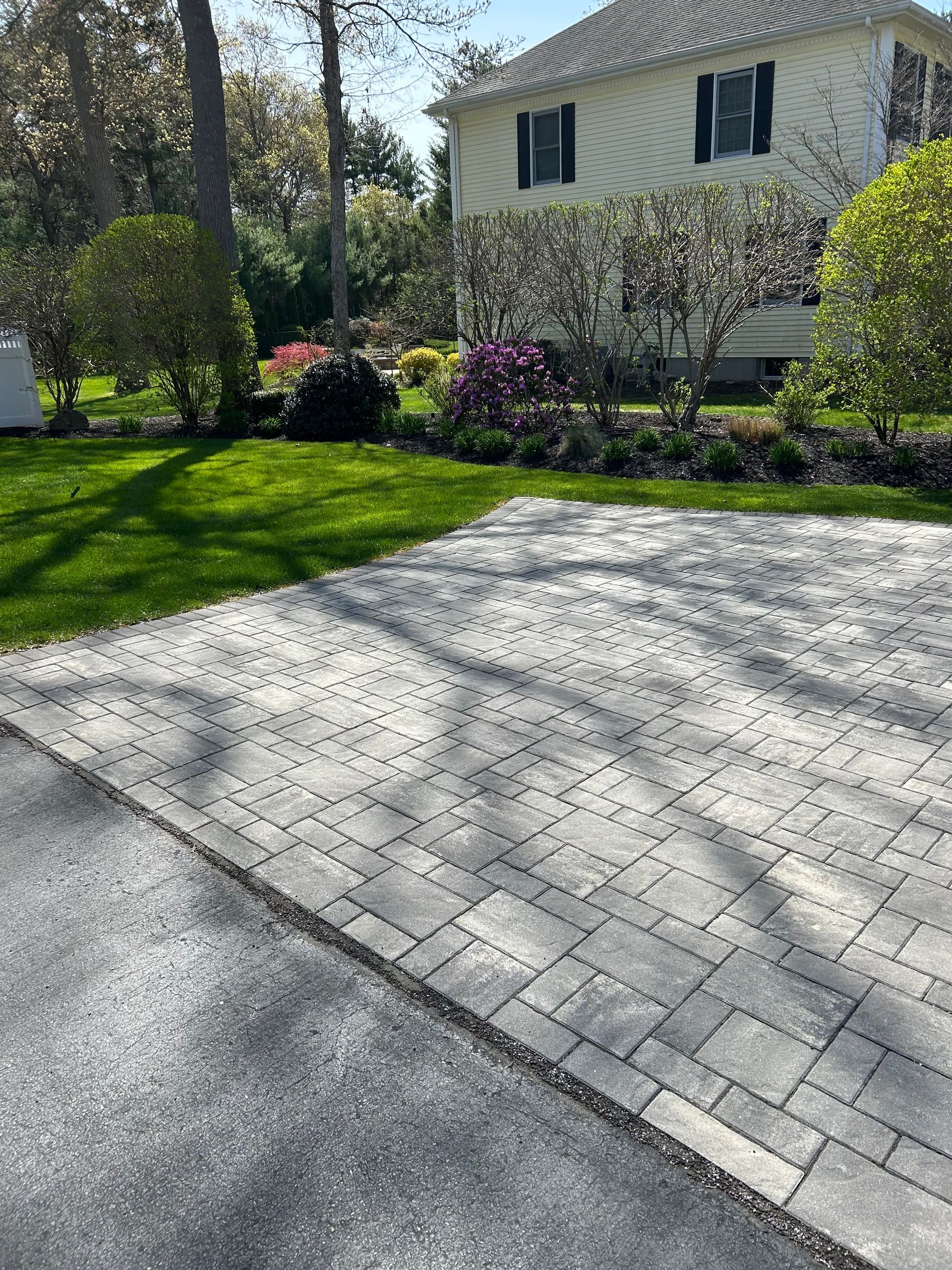 A driveway with bricks in front of a house.