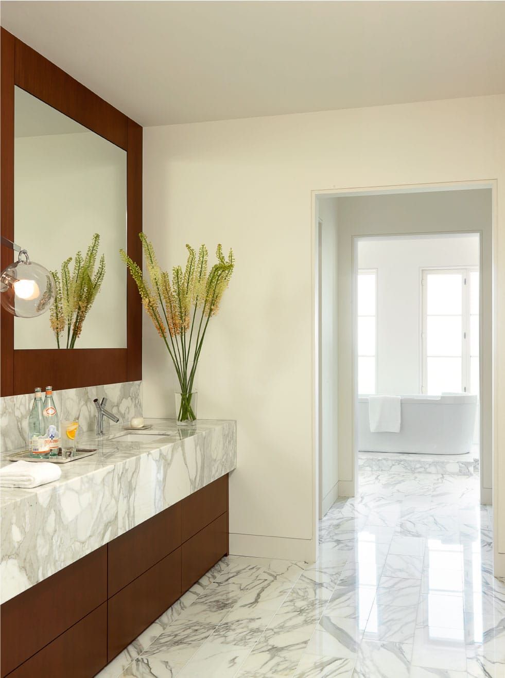 A bathroom with two sinks and a large mirror
