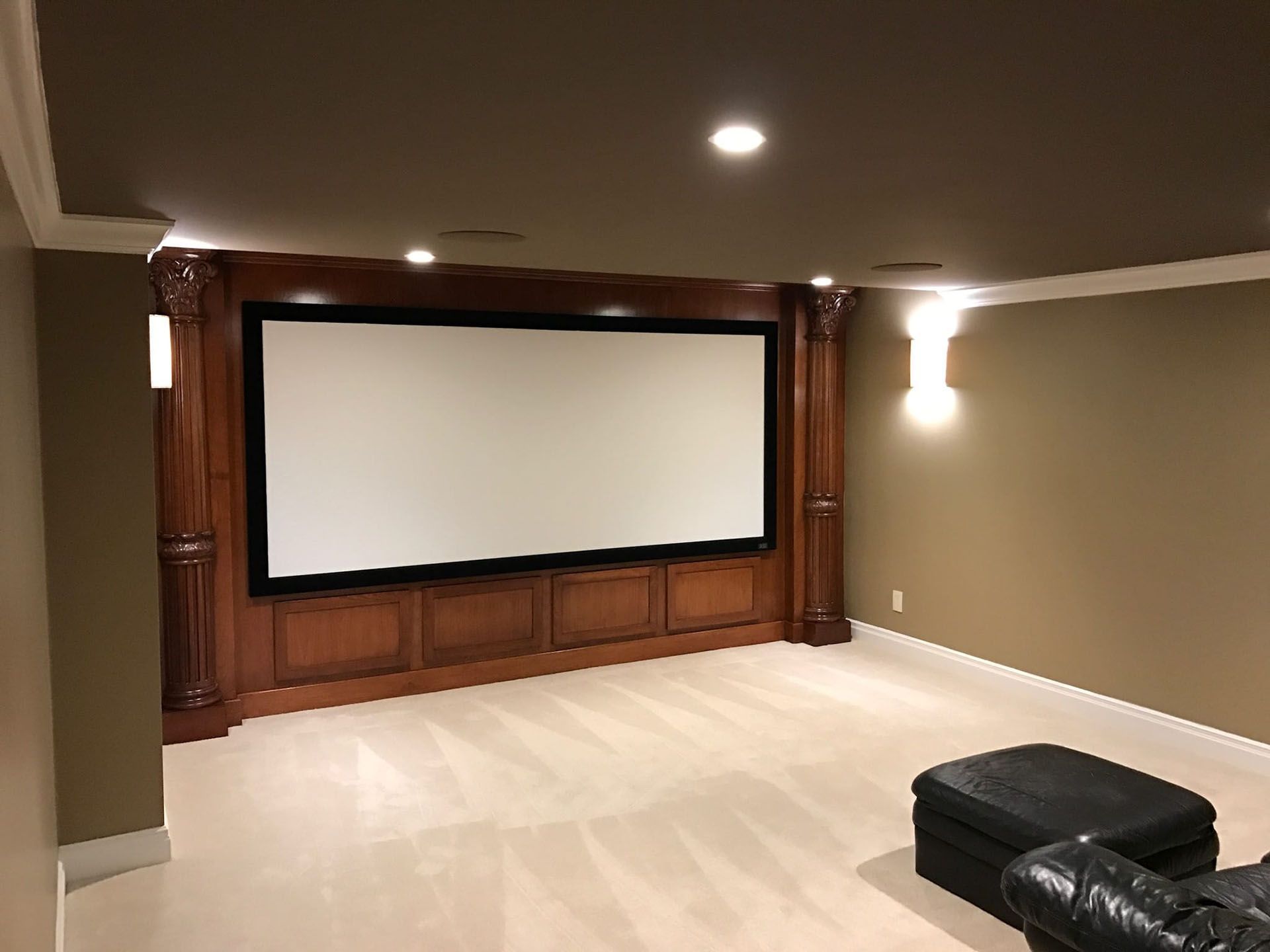New interior remodeling project - a home theater with a large screen and a couch.