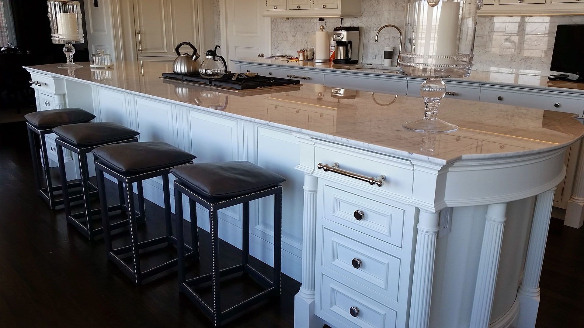 A kitchen with a large island and stools