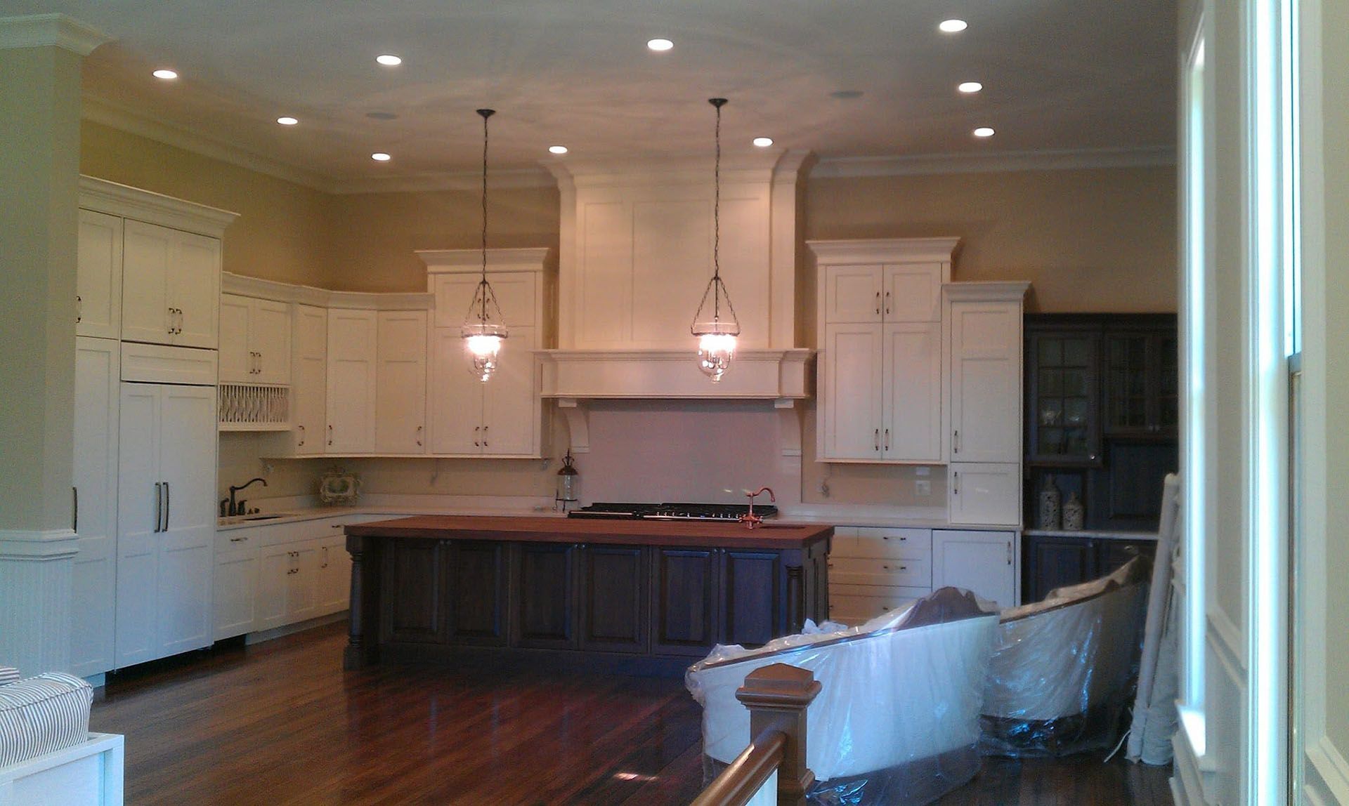 A large kitchen with white cabinets and a large island.