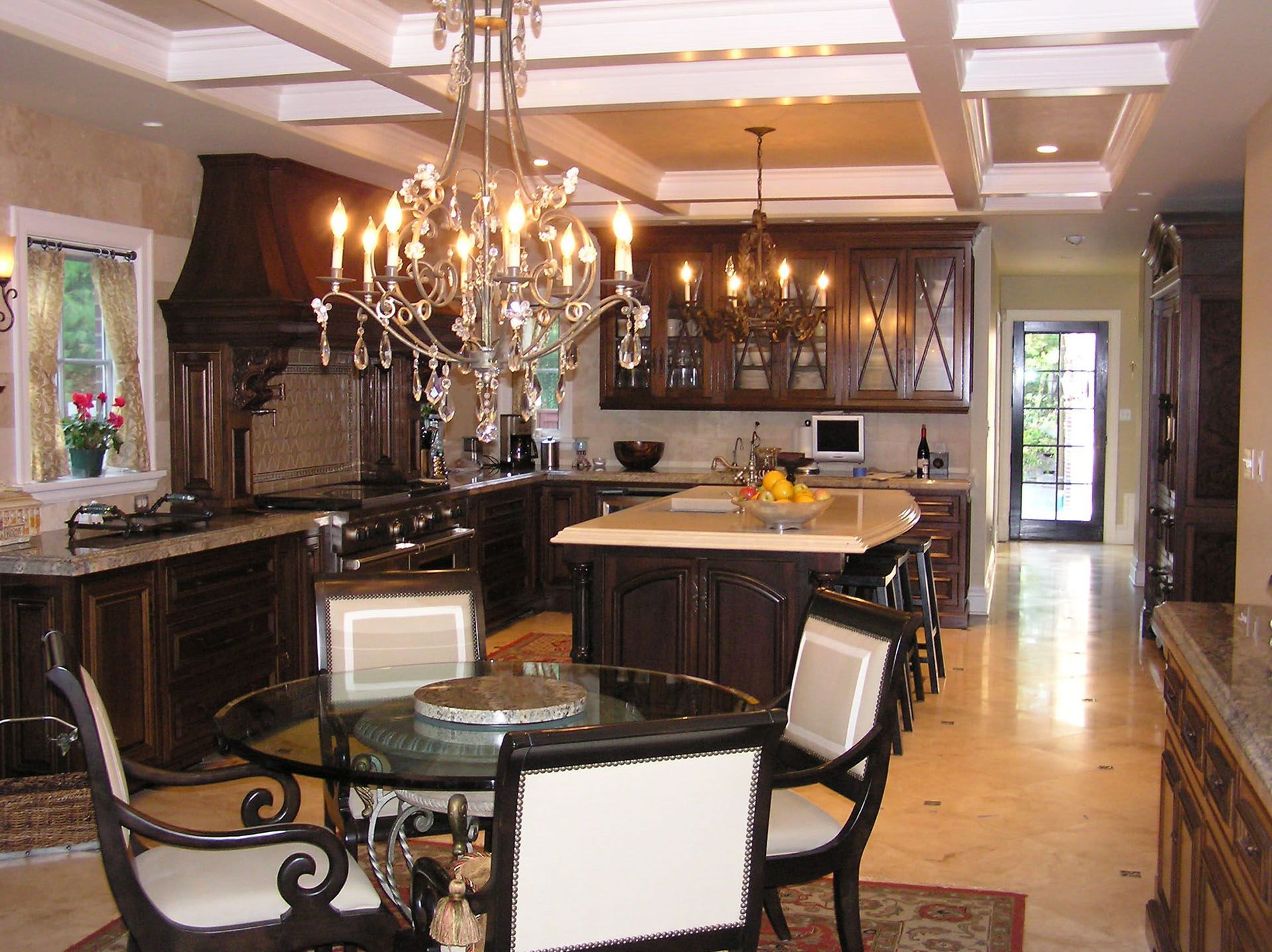 A kitchen with a table and chairs and a chandelier