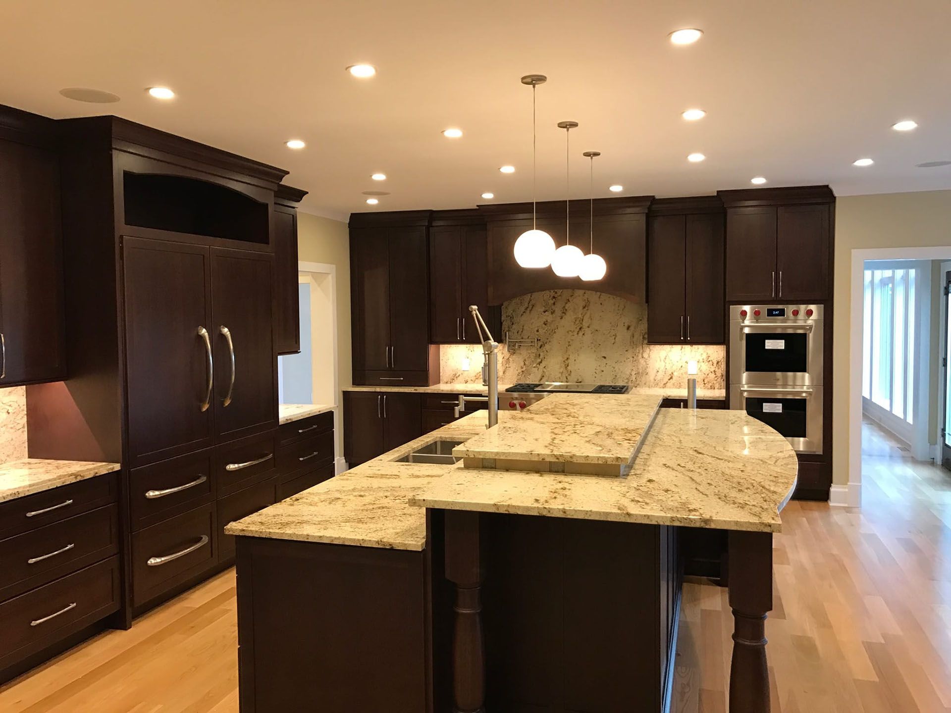 Kitchen with custom cabinetry and hardwood flooring