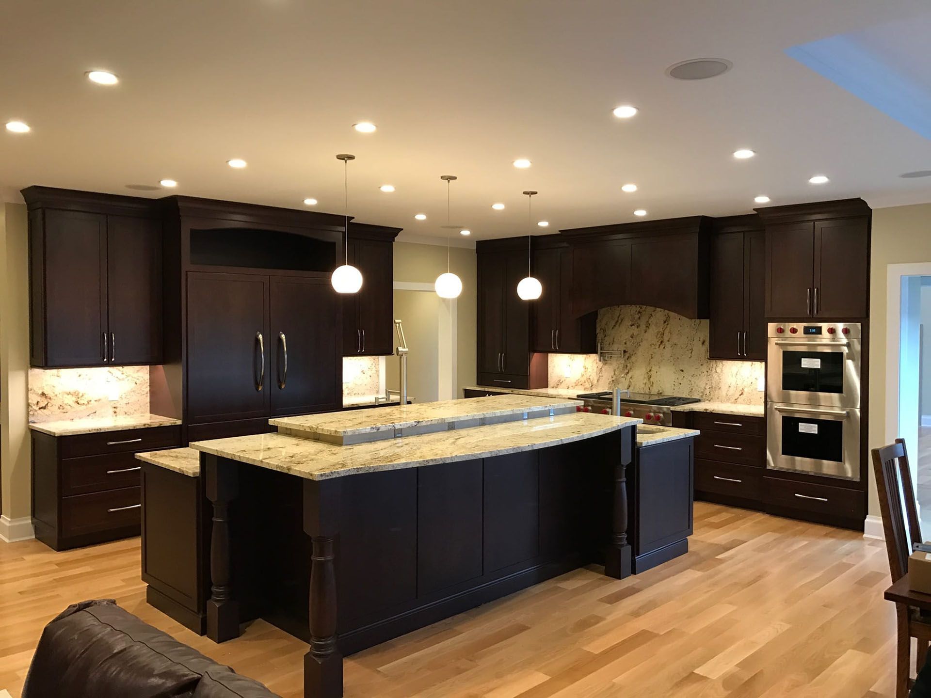 New kitchen with custom lighting and marble countertops