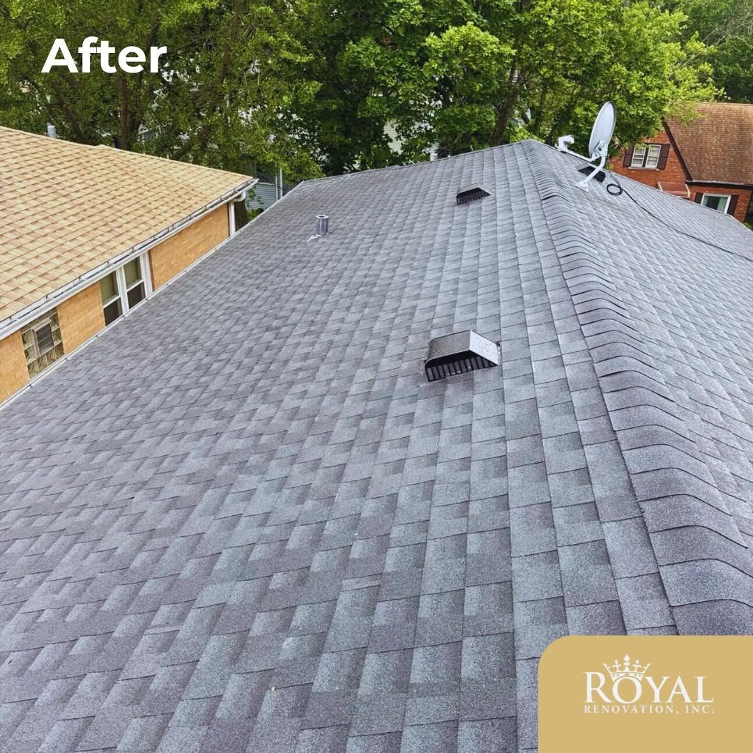 Gray shingled roof after repair with vents and satellite dish, viewed from above beside trees and neighboring houses