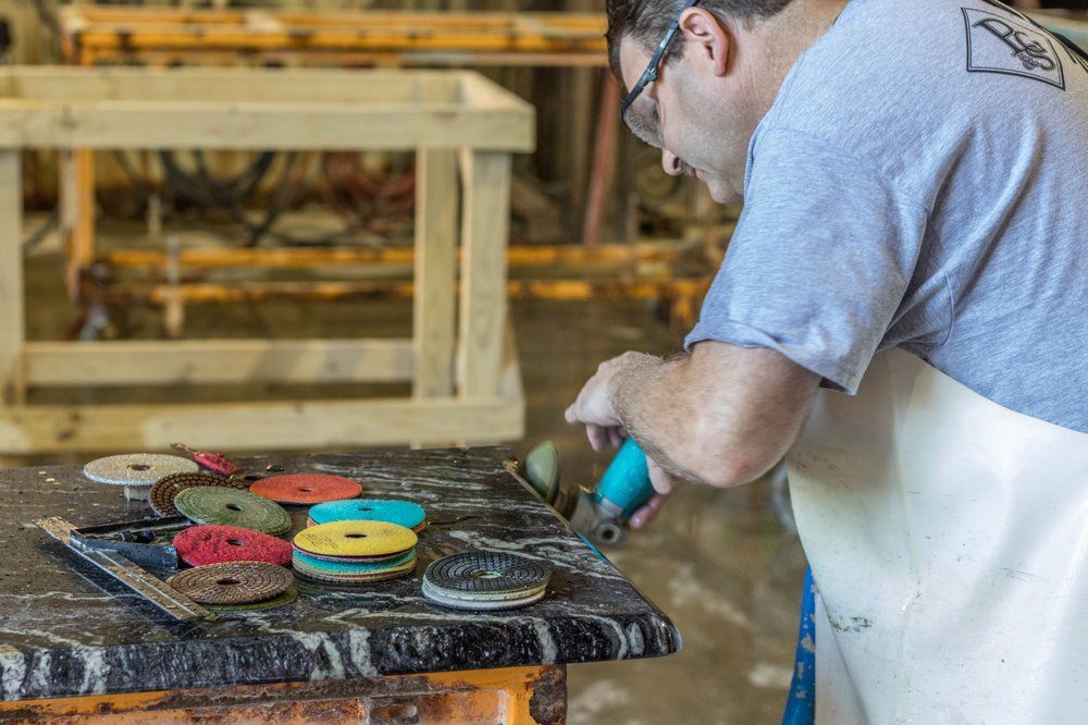 A man is grinding a piece of wood with a grinder.