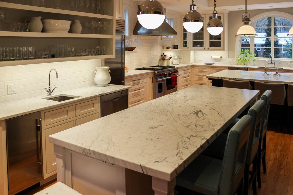A kitchen with a large island and stainless steel appliances