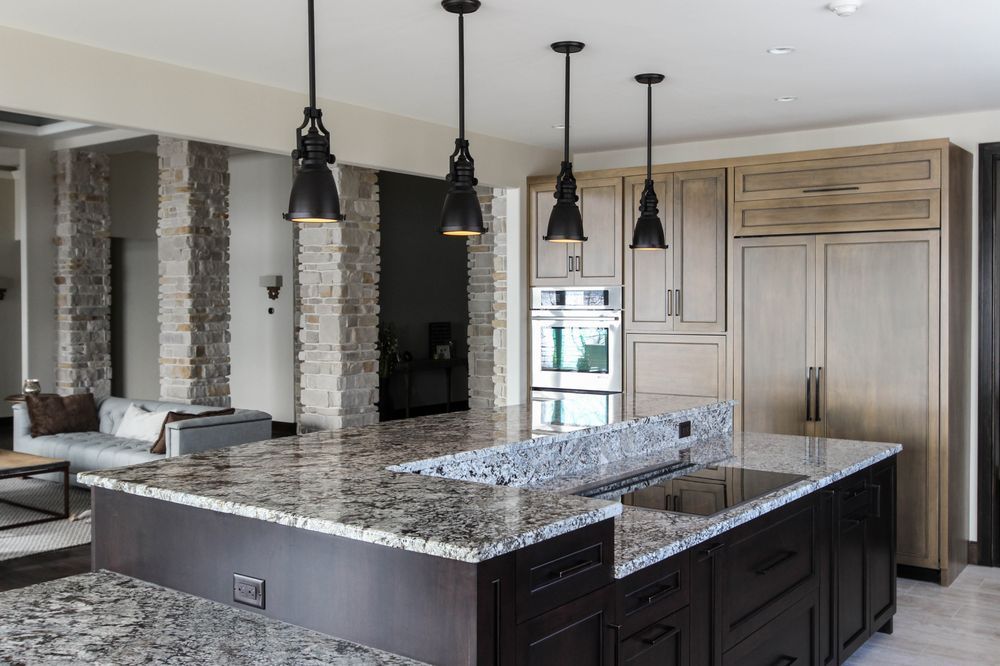 A kitchen with granite counter tops and stainless steel appliances.