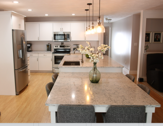 A kitchen with a vase of flowers on the counter