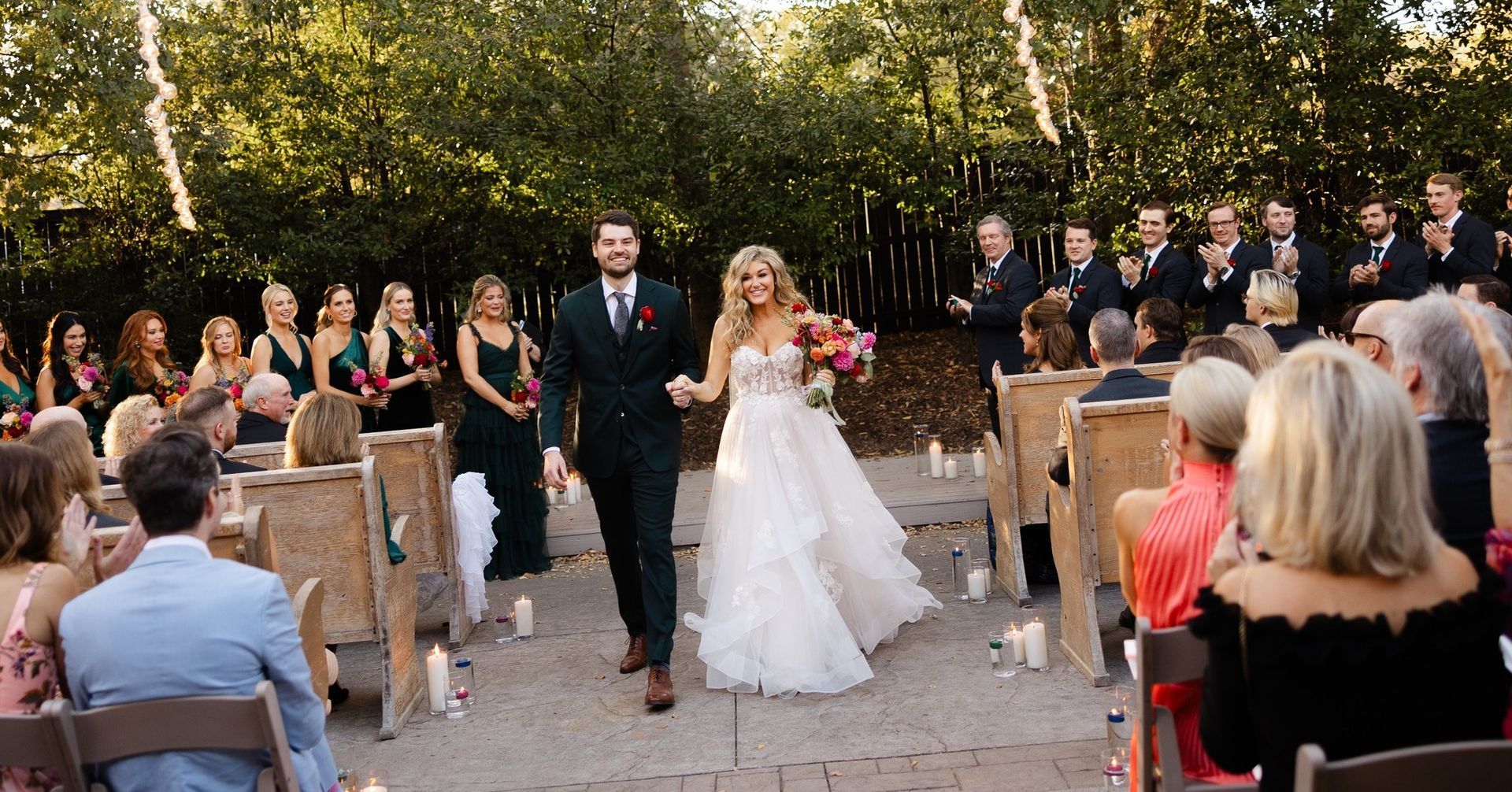 A bride and groom are walking down the aisle at their wedding.