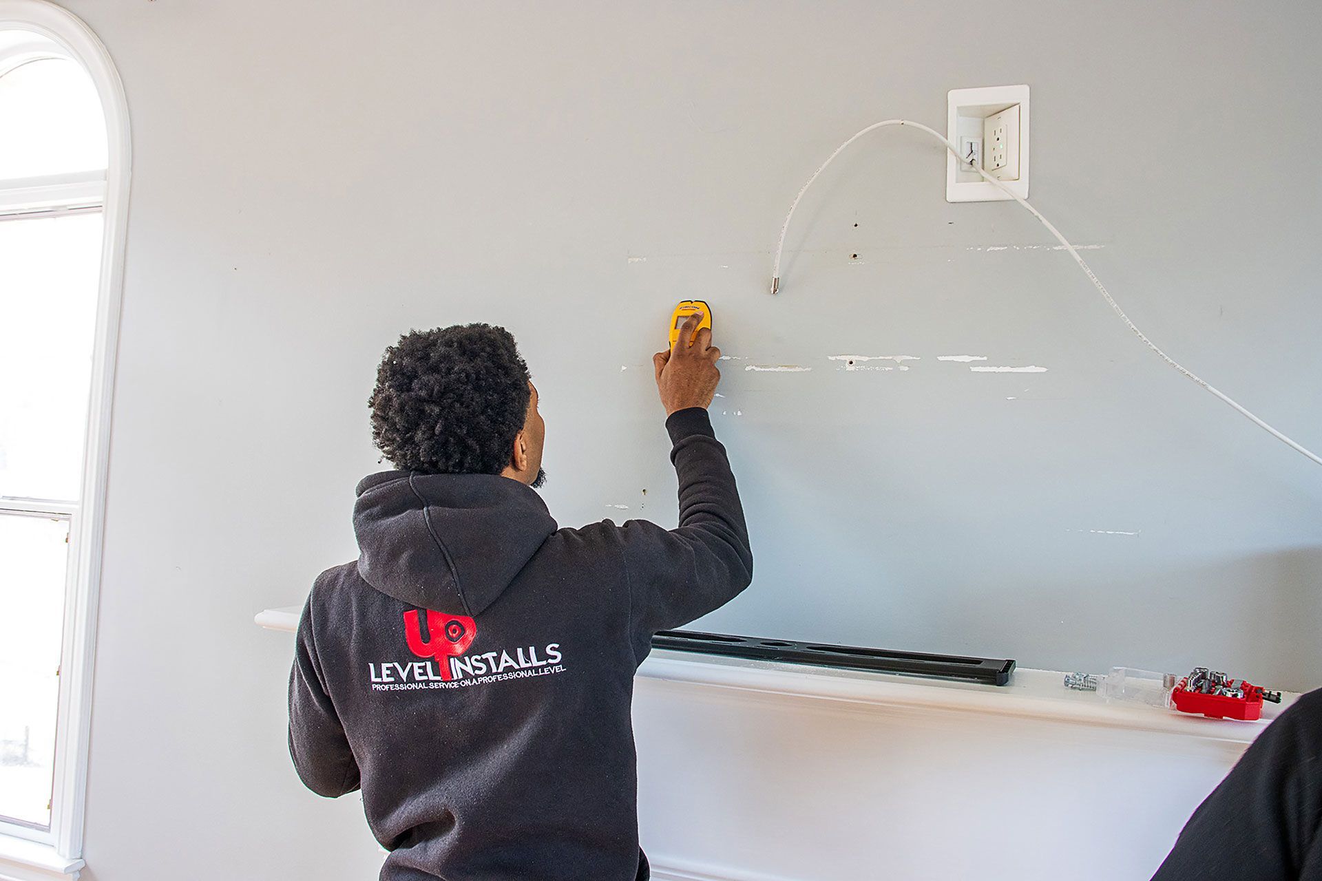 man preparing the wall for the TV