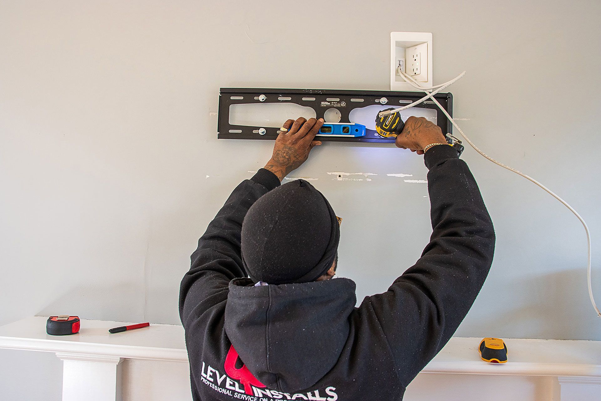 man installing the TV brackets