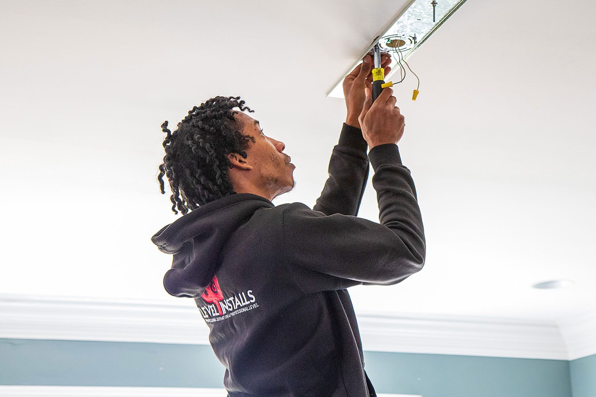 man installing the ceiling light canopy
