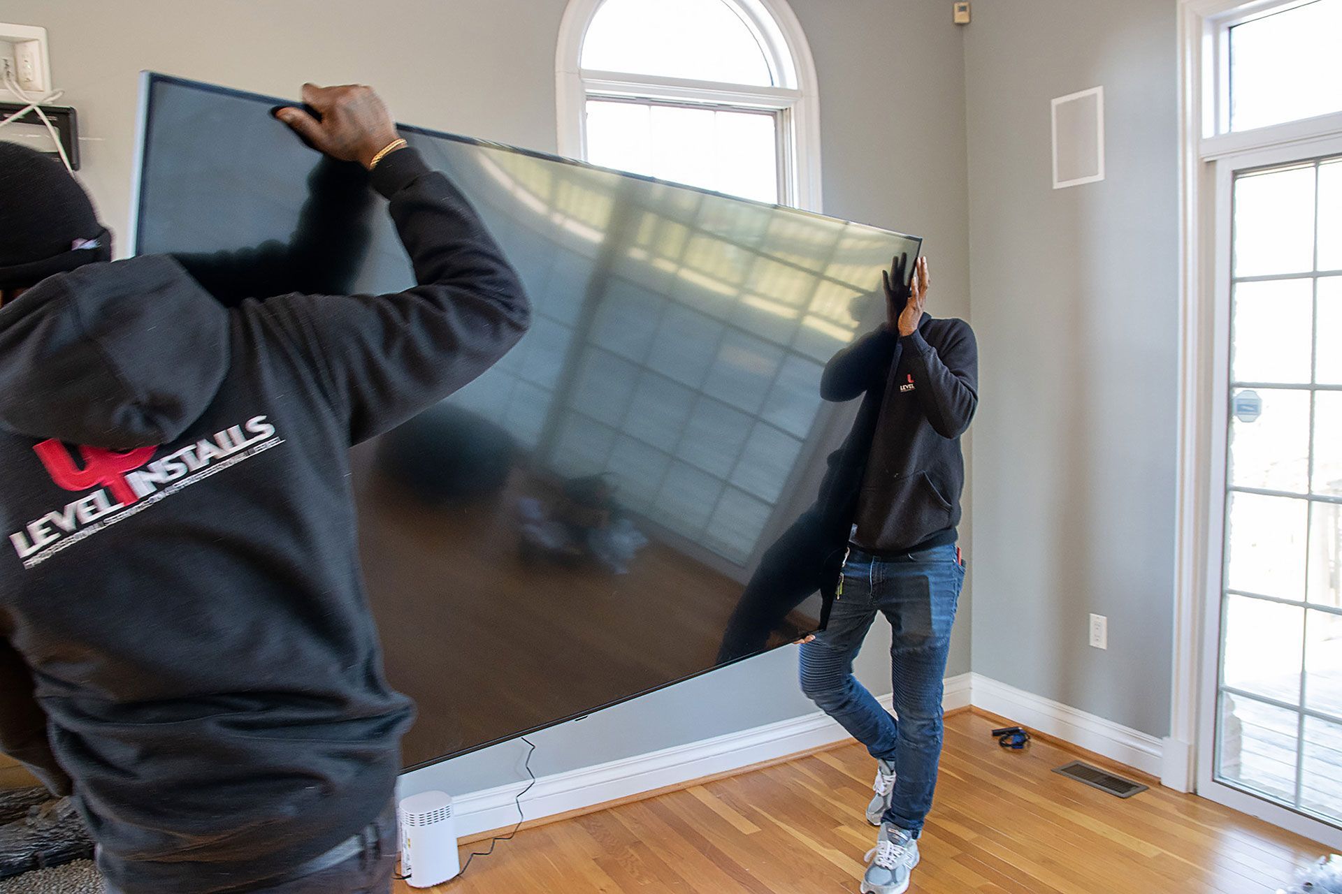 two men carrying the TV