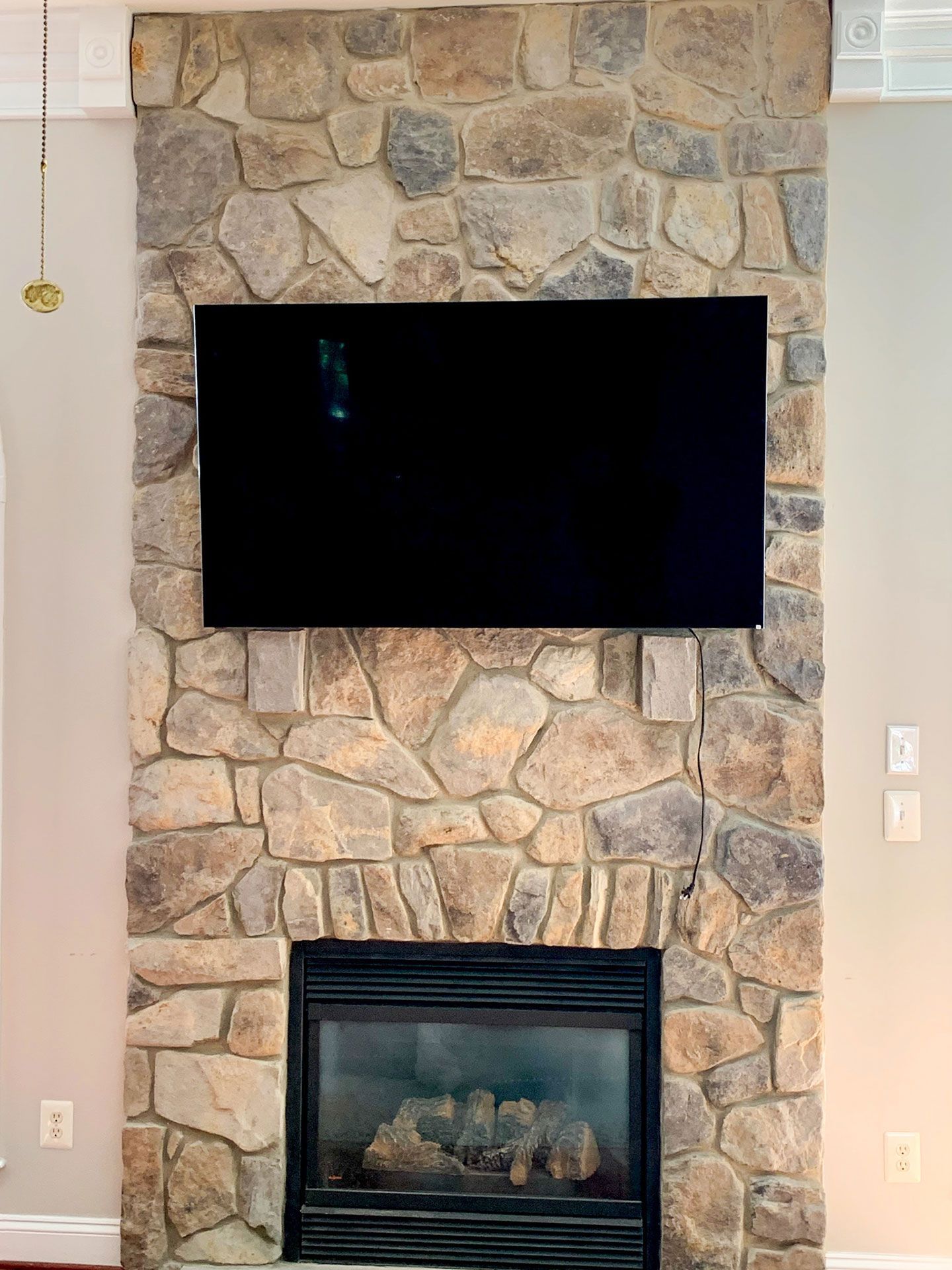 flat screen tv above the fireplace