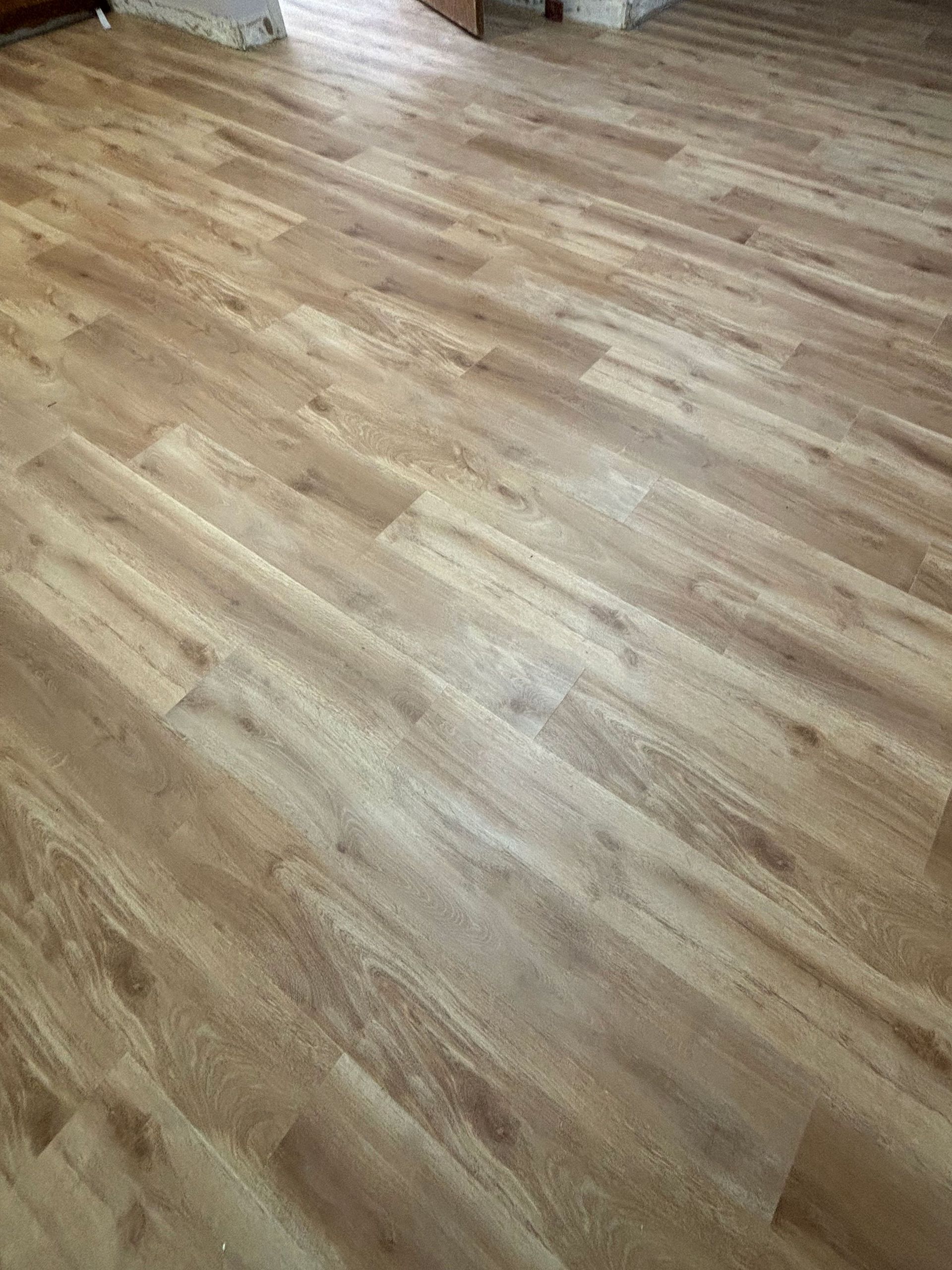 Wood-patterned laminate flooring filling the frame