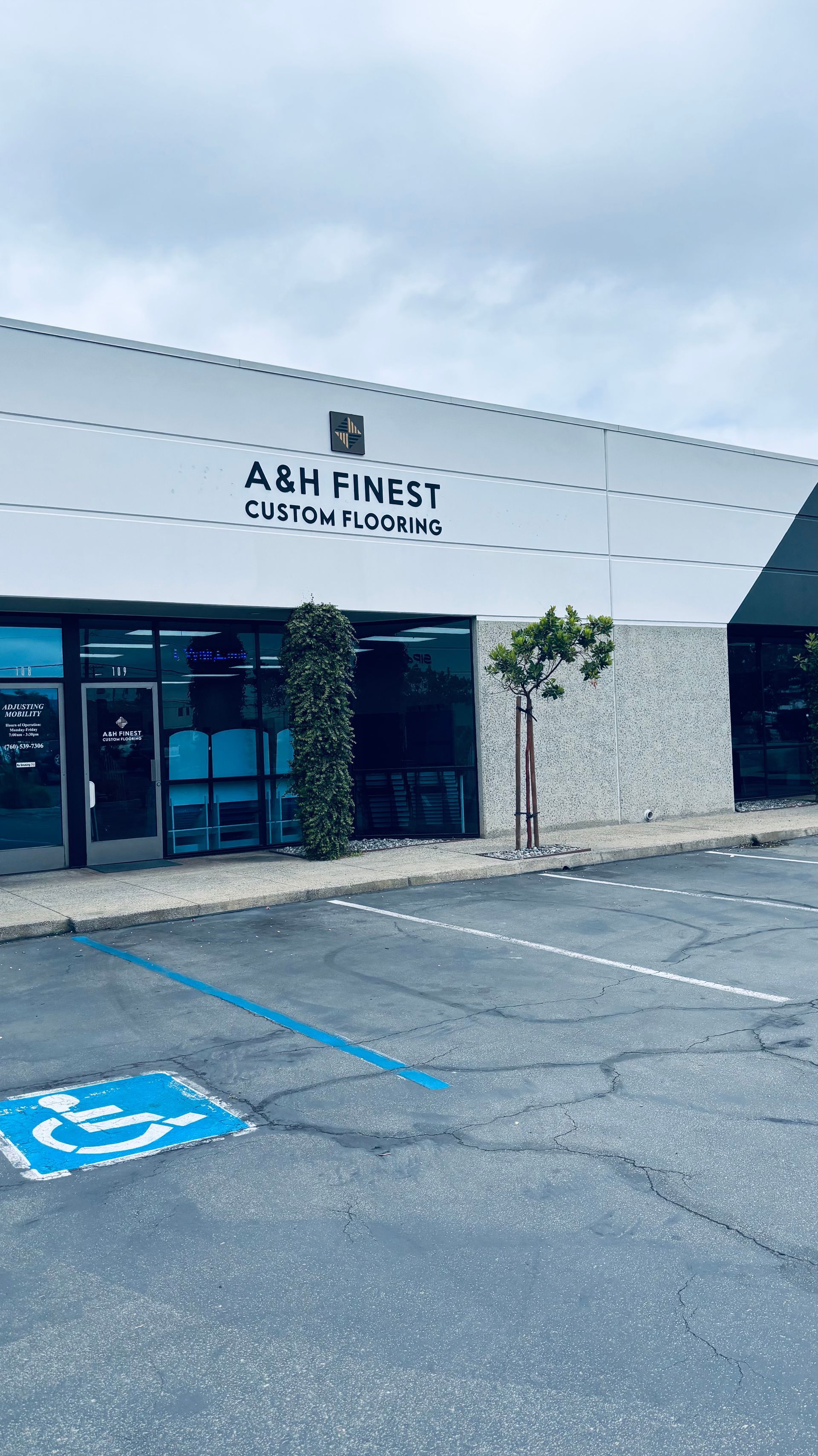Storefront of ABH Finest grocery with blue accessible parking spaces in front