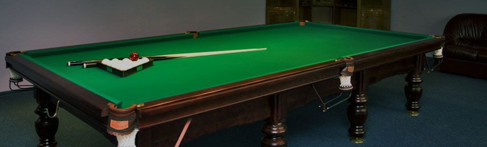 Pool table with cue and balls on top